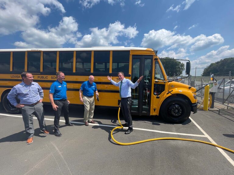 Senator Warner plugging in a Virginia electric school bus